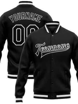 Black custom varsity jacket with white striped cuffs, personalized team name on the front, and custom name with number on the back.