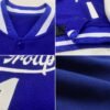 Custom blue and white varsity letterman jacket with personalized team name and number